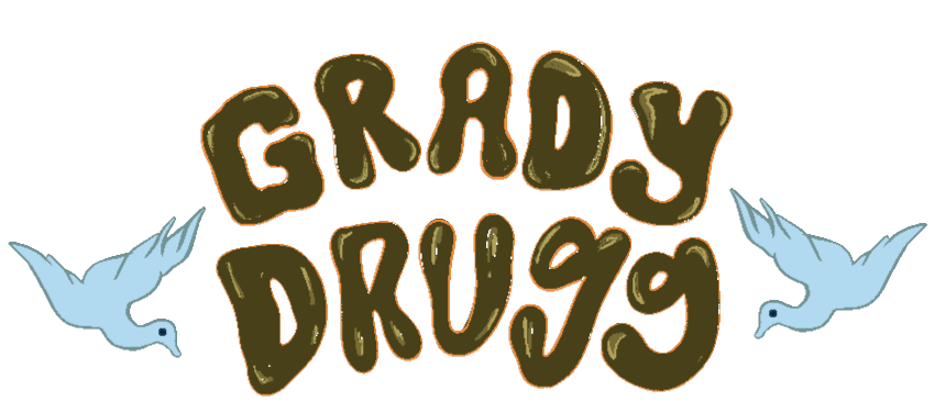 A sketch of the words 'Grady Drugg' in bubbled, retro-looking olive green lettering with a pale orange outline. The words are sandwiched by mirrored sketches of blue-tinted doves, each with a beady dark blue eye.